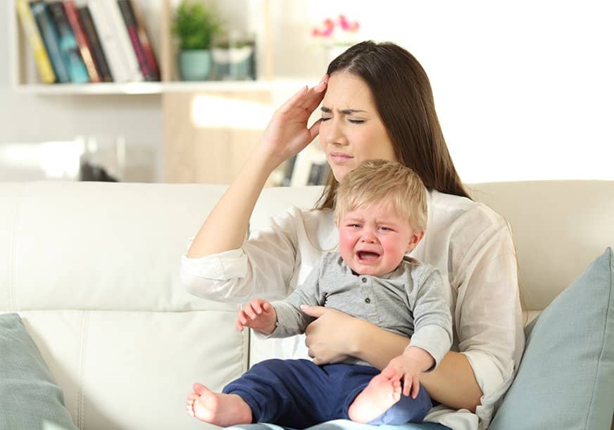 A woman is tired of her screaming baby