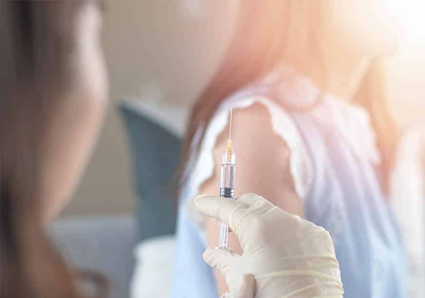 A doctor prepares an injection for HPV