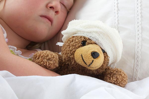 a child sleeps with a teddy bear