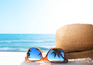 sunglasses and a hat on the beach