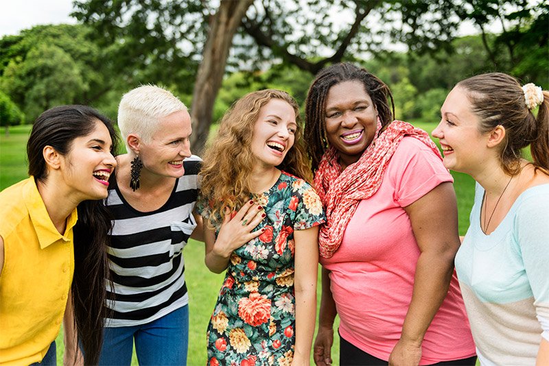 a group of women laugh together