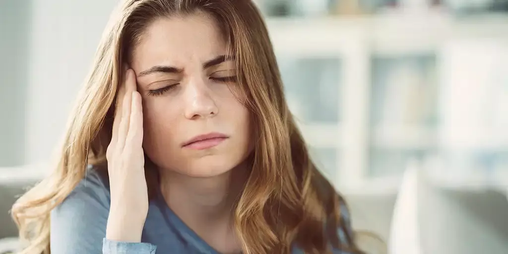 Woman with headache symptoms