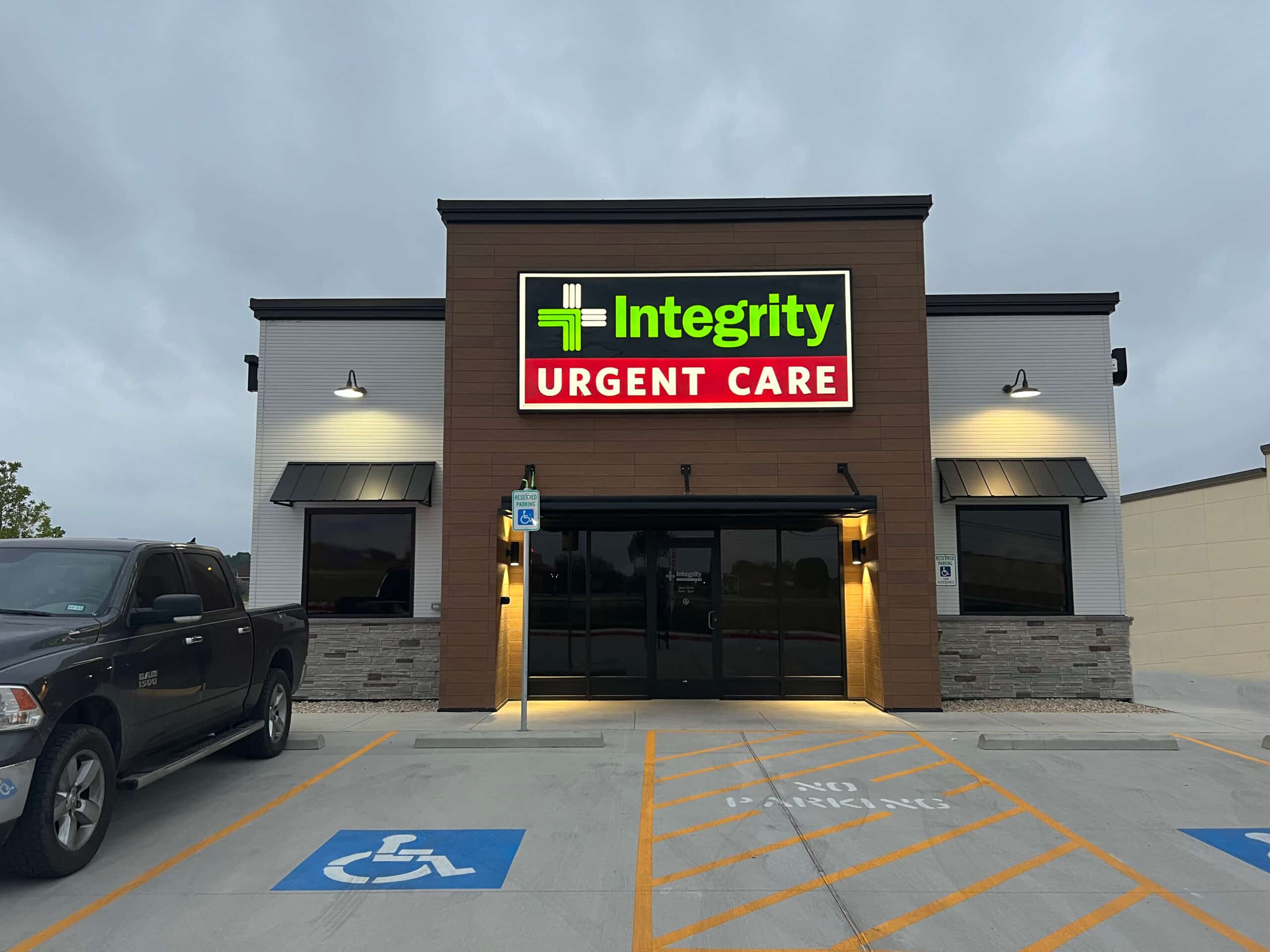 A photo of a sleek looking brick building with a sign naming it as Integrity Urgent Care of Alvarado.