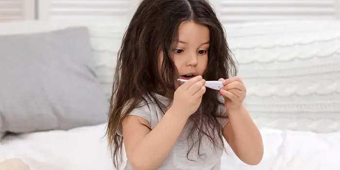 Integrity Urgent Care - Do you have the flu? blog photo of little girl looking at thermometer